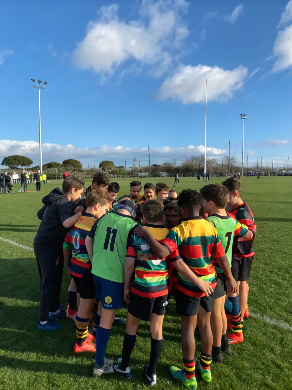 Action shot of young rugby players participating in a training session at RCAV Rugby Club, focusing on teamwork and skill development.